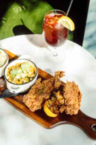 Fried food and a side on a platter with a glass of tea