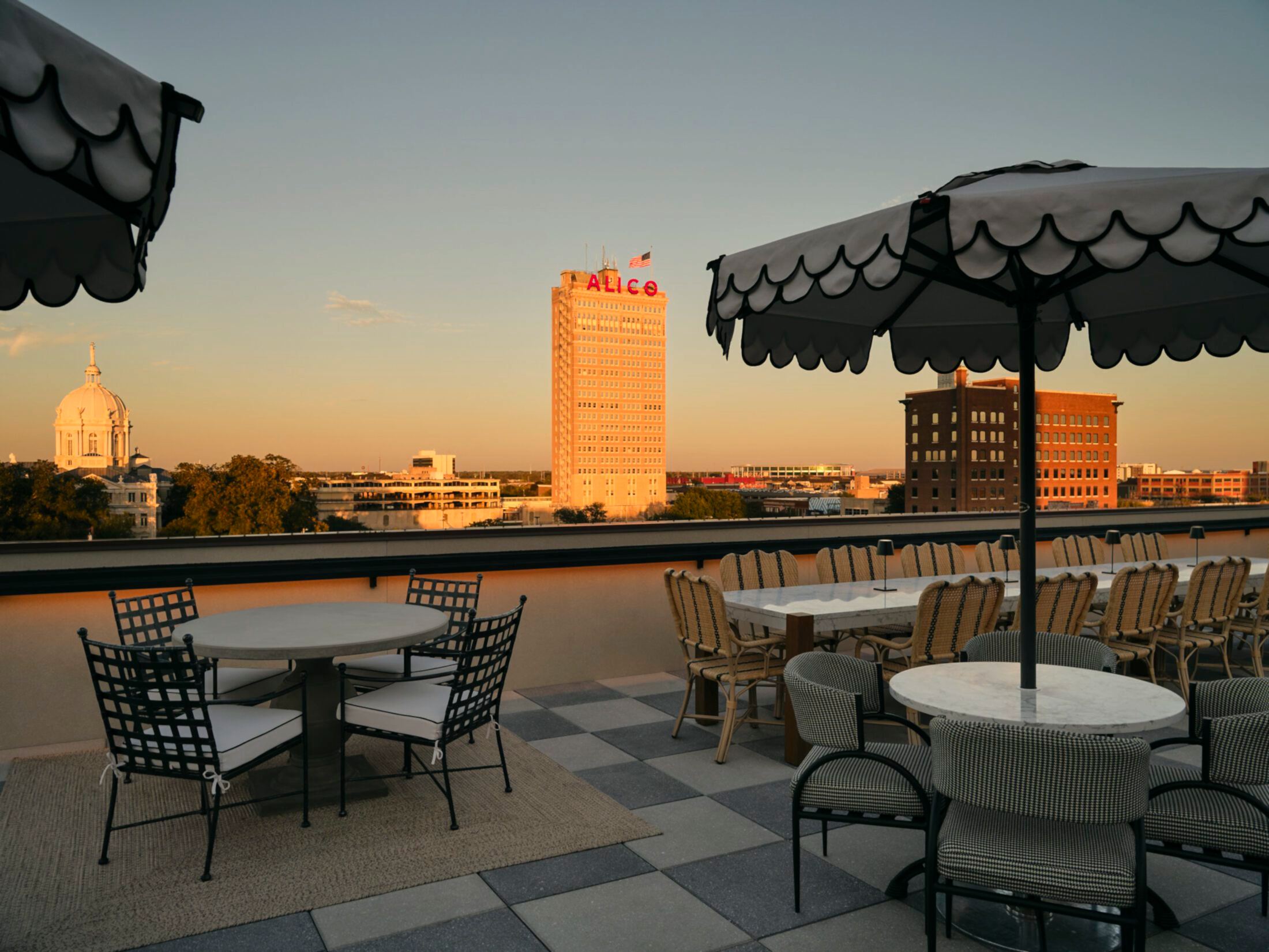 Rooftop dining area with seating and a view of Waco, Texas skyline